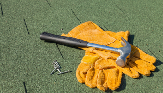 Hammer and nails on flat roof